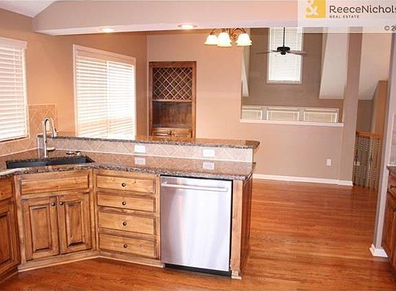Kitchen with stainless appliances and granite counters.