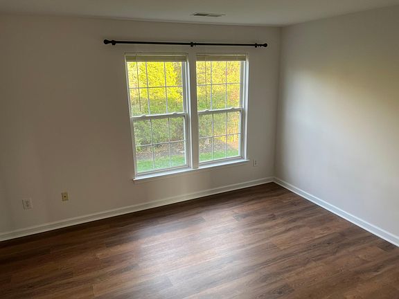 Master bedroom with large walk-in closet and view overlooking deck and backyard
