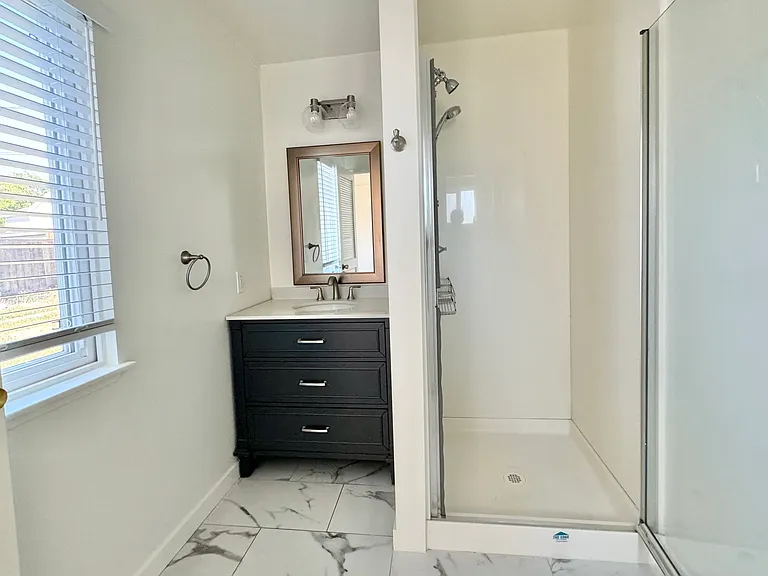 Primary bathroom with vanity and shower.
