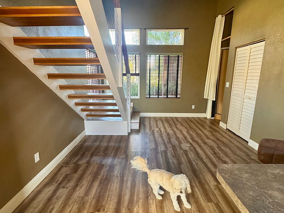 Behind the stairs to front of apartment.