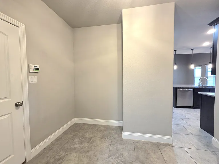 large open space, room form desk next to garage and laundry room
