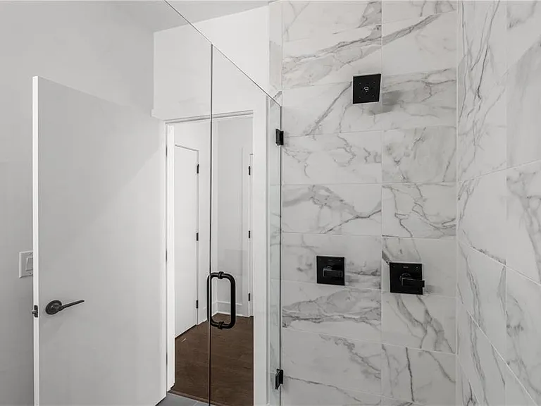 Main Bathroom (Note: Actual unit has light wooden floors and upgraded fixtures / appliances)