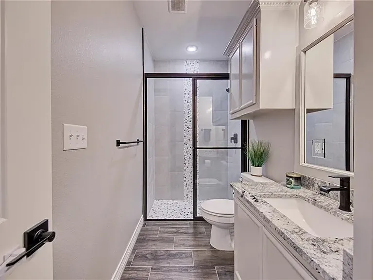 Guest Bathroom featuring a walk-in shower with a clean, modern design.