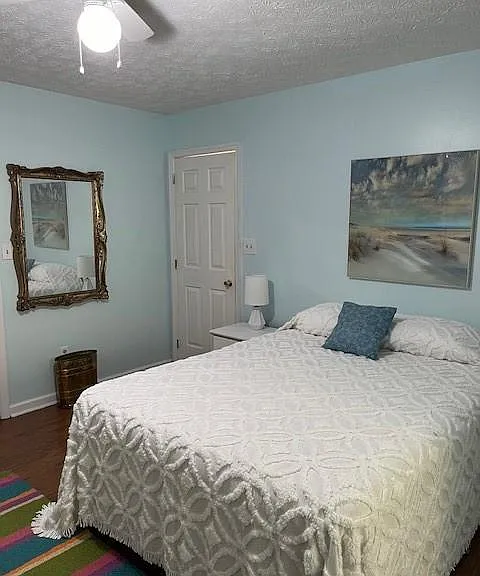 Furnished bedroom with queen size bed, dresser, etc