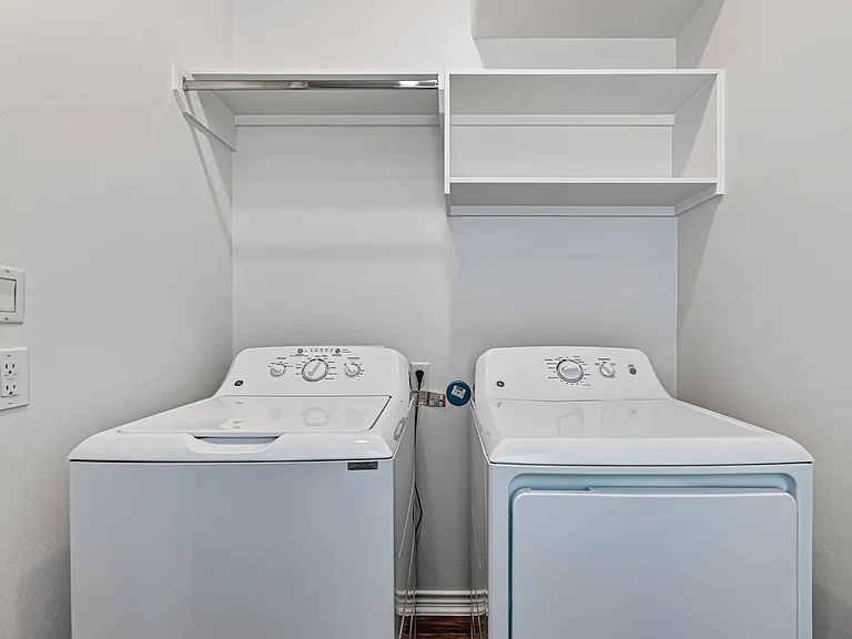 Second-floor laundry area with washer and dryer included