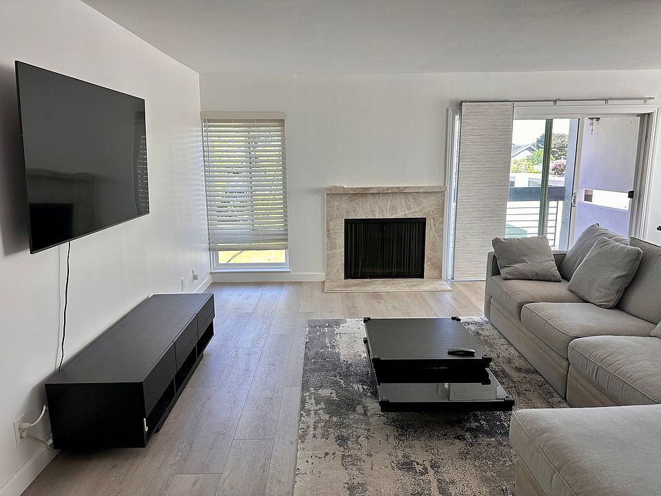 Living room with L-shape sofa and mounted 65'''' TV