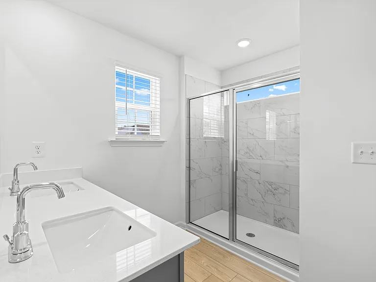 Master Bathroom Featuring Double Sinks, Walk-in Shower and Tiled Walls in Shower