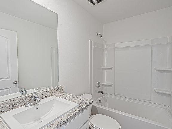 The master bathroom includes a tub shower combination