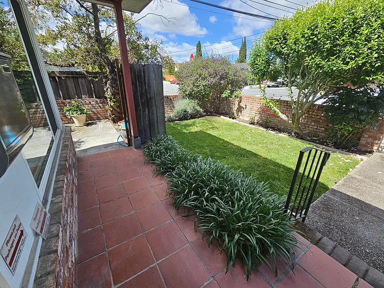 Front Yard, with brick wall around property and front gate.