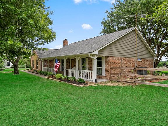 The lush green grass and large trees are abundant on this property.