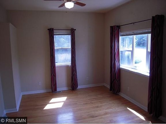 Living room with original hardwoods and bay window.