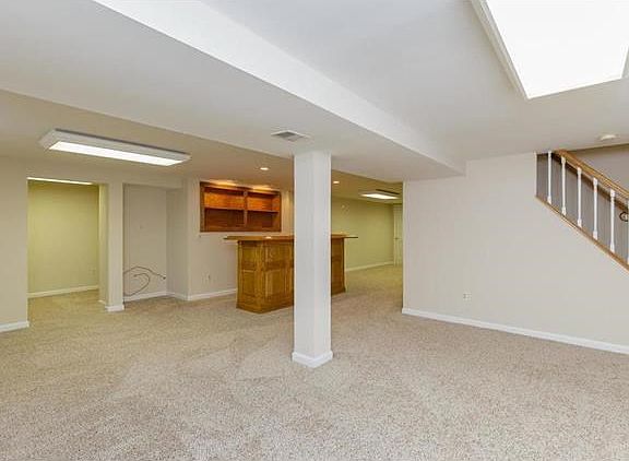 Finished lower level with wet bar, family room, recreation area, office space, a great finished laun