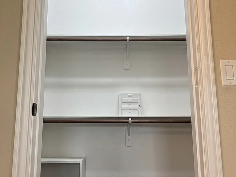 Vaulted ceilings in the walk-in closet with built in storage on the left and right