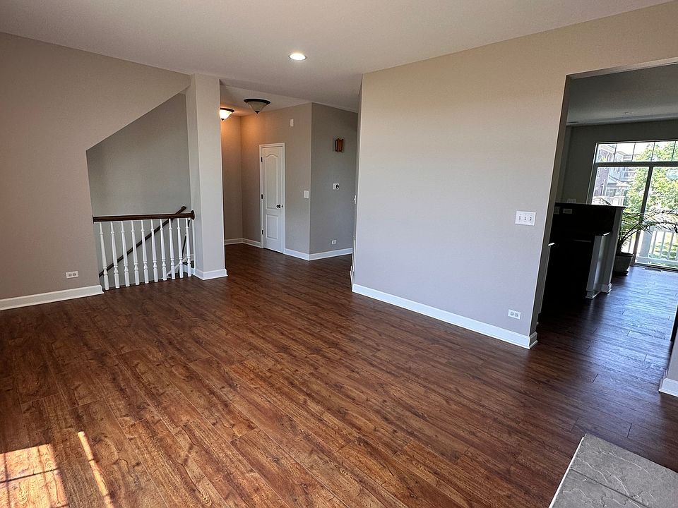 living room-main floor with balcony overseeing park, walking paths and fountain