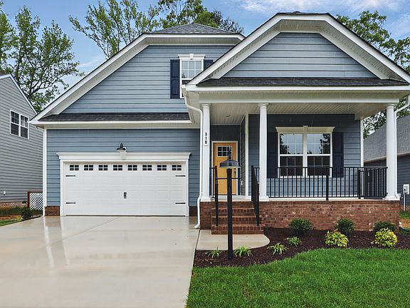 Charming blue single-story home with white trim in Somerset Hill, featuring a porch, garage, and lan