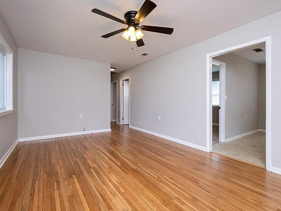 Living Room - large picture window, refinished hardwood floors, ceiling fan