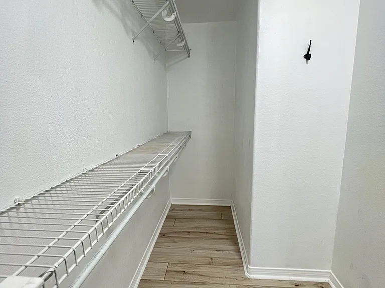 Walk in closet in the primary room.