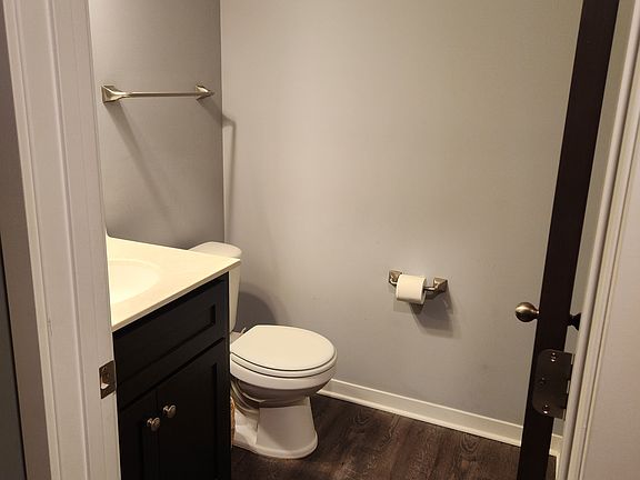 Convenient main-floor powder room.

 This half-bathroom is perfect for guests, featuring a modern vanity and durable flooring.