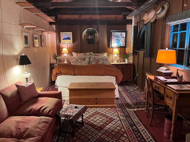 New queen bed in sleeping area of Studio. Two work tables here - Sliding doors separate sleeping from the Kitchen and sitting area. Couch and wood chest now in adjacent sitting room/kitchen!