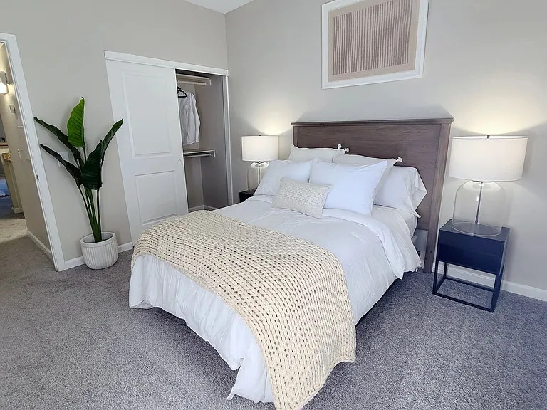 Our guest bedrooms feature plush carpeting and spacious closets with dual shelving, offering functionality and convenience.