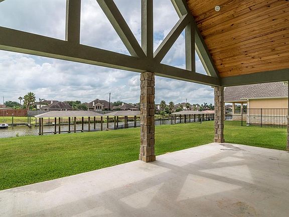 VIEW OF THE POOL SIZED BACKYARD AND 40' BOATHOUSE WITH TREX DECKING. SELDOM WILL YOU EVER FIND NEW CONSTRUCTION ON THE WATER COMPLETE WITH A BOATHOUSE!