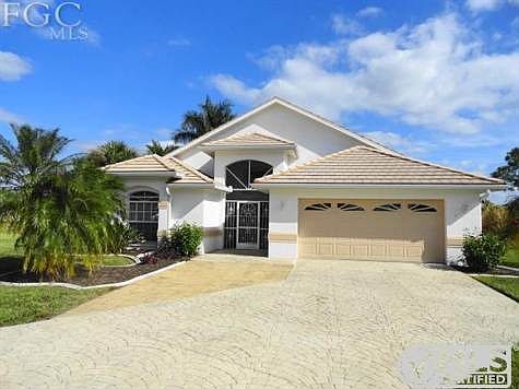 Front of Home. Note the Slate Style Tile Roof, Stamped Concrete Driveway + Screened Entry for cross 