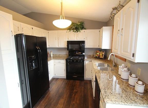 Nice kitchen with granite, white enamel cabinets and nickel finishes.