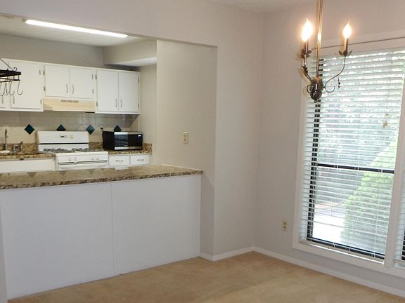 Dining room and breakfast bar. Kitchen with lots of cabinets, microwave, granite counters