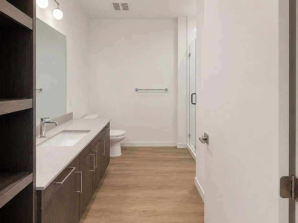 Modern bathroom featuring a walk-in glass shower and spacious vanity.