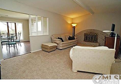 Vaulted ceiling in family room with brick fireplace. Adjacent ga