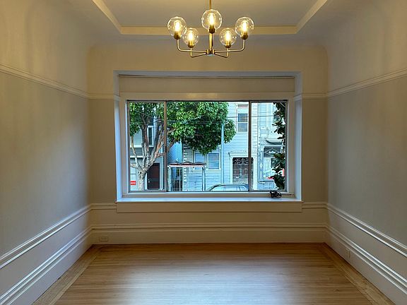 The adjacent living room faces Church Street and features a vaulted ceiling and other period details.