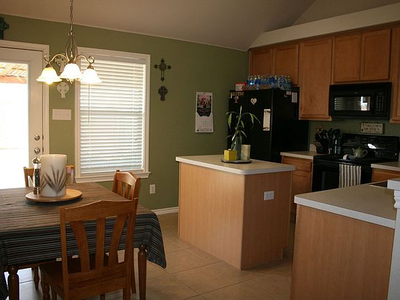 Kitchen with island, tile, and energy star fridge
