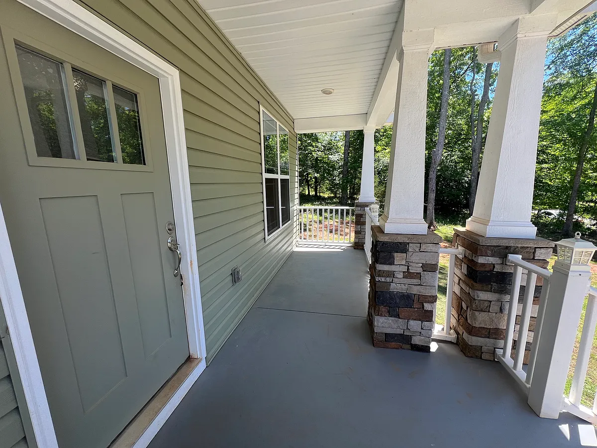 Covered front porch, perfect for morning coffee and watching the sun come over the lake. - 103 Angler Dr