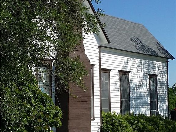 Side of the home with a drive that goes to the back of the home for parking