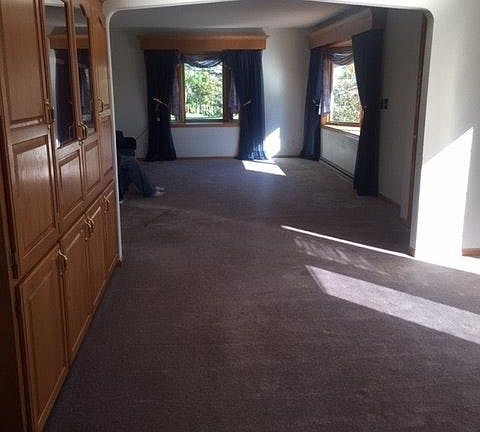 Large open space looking from kitchen to dining room and liv