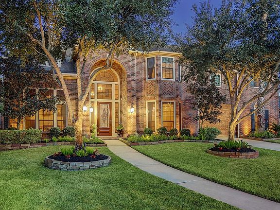 The curb appeal is outstanding with professional landscaping and a lush grassy lawn, a gorgeous traditional brick elevation with handsome coach and landscape lighting, a porte cochere, and a three car garage.