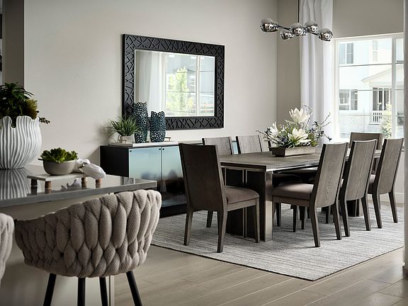 A modern and stylish dining room with a large wooden table, plush upholstered chairs, and a decorati