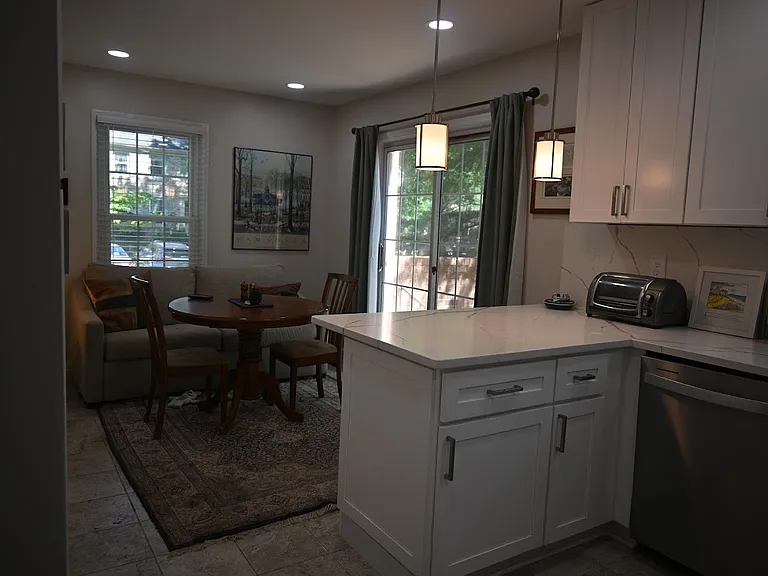 Kitchen with adjacent breakfast nook accessible to patio