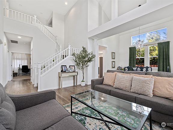 alternate view of living room highlighting the wrap up staircase so light and bright in here!>