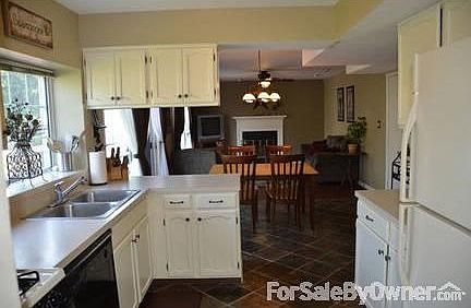 Kitchen
						:
						Neutral countertops, window box shelf, ceramic backsplash, slate flooring