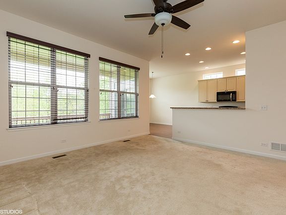 overlooking covered deck and opening to kitchen