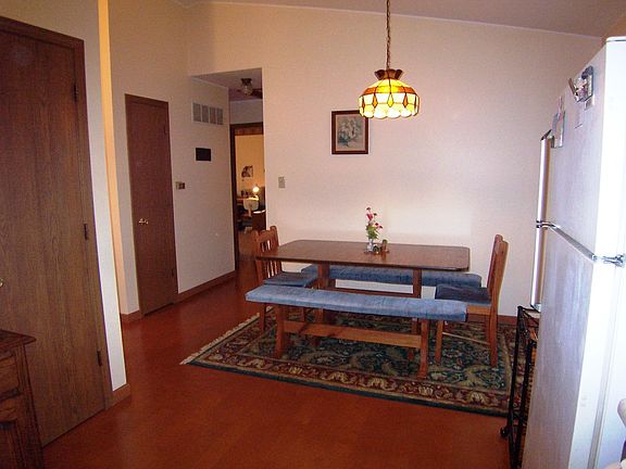 Dining area off kitchen showing hallway to bedrooms