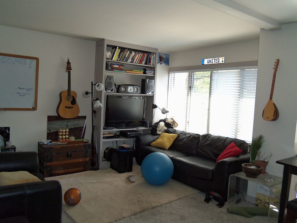 Living area with built in bookcase and wall of windows