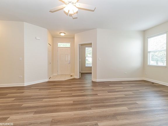 View of entryway, den & living room