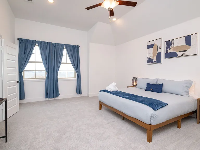 Primary bedroom with smart tv and extra blankets/towels available for use