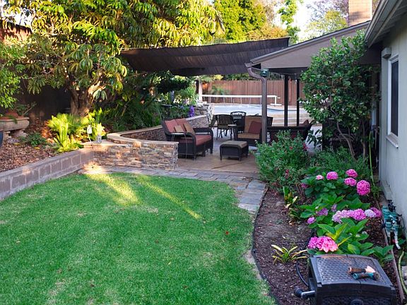 Shaded furnished patio and grass & flower areas
