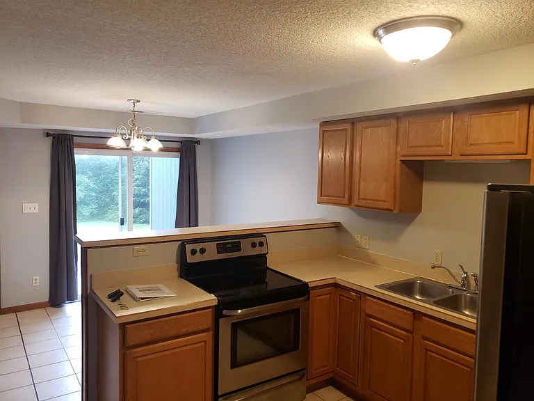 Kitchen view, looking at dining room to sliding patio door / back patio access