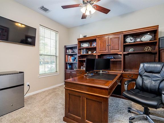 Tucked behind double etched glass doors, you will find this private study with views of the front yard space! Soft frieze carpet helps with long days of possible conference calls!