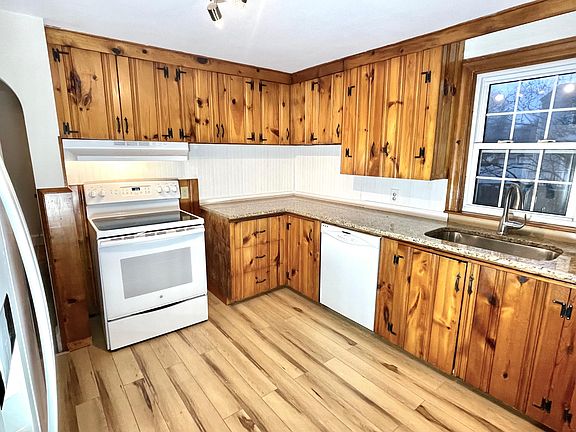 New granite countertops, sink, and faucet, new wainscoting backsplash, new floor, new appliances