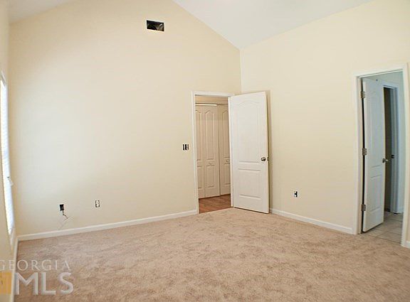 master bedroom with vaulted ceiling